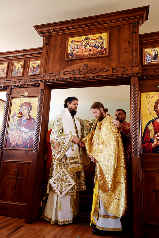 The Rev. Daniel Kirk receives his vestments, the robe worn by clergy, on Sunday, July 19. (Brenda Ahearn/Daily Inter Lake)