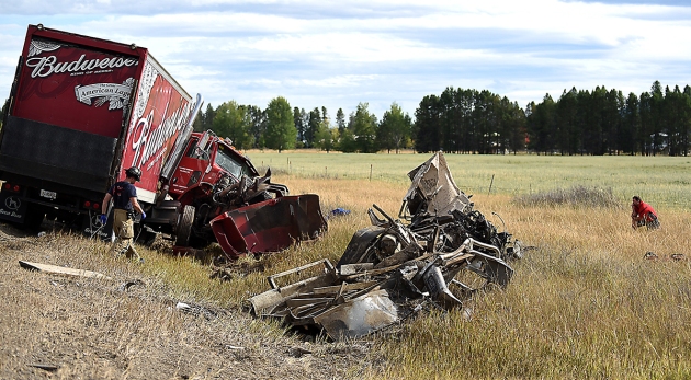 One of the most devastating wrecks I have ever seen: The driver of a Budweiser truck takes a moment off to the side of a collision with a Ford f250 truck on September 9, at the intersection of U.S. 93 and Farm-to-Market Road north of Whitefish.